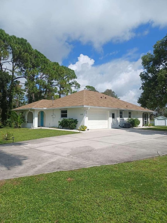 view of front facade with a front yard and a garage