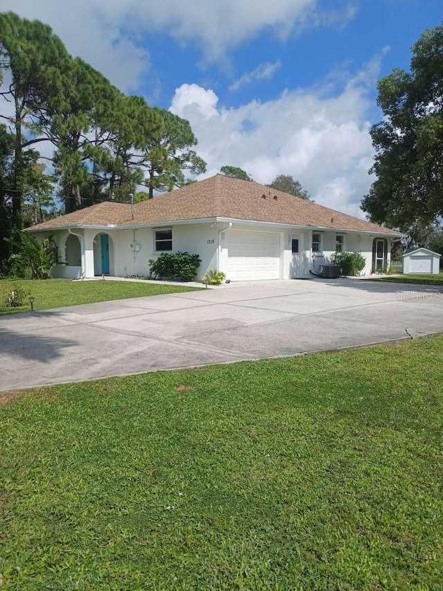 single story home with a garage and a front lawn