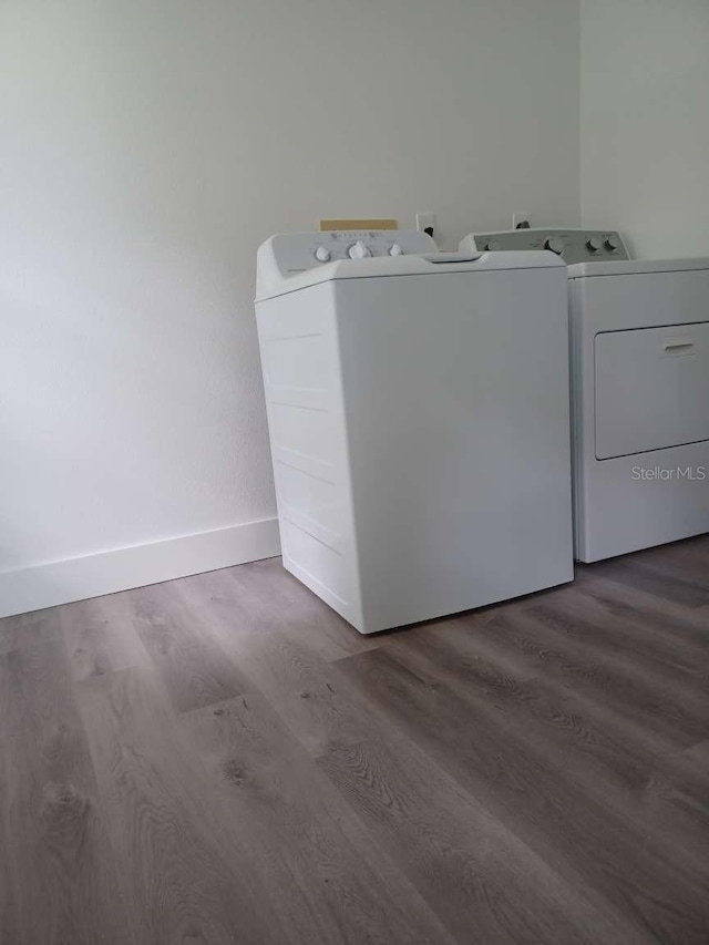 washroom featuring wood-type flooring and separate washer and dryer