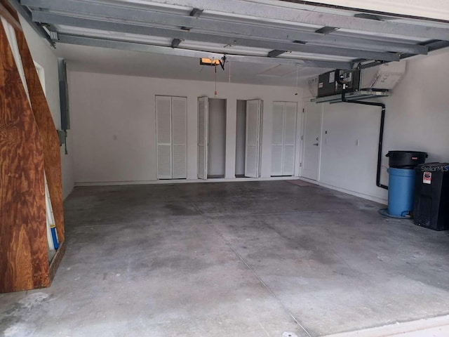 garage with a garage door opener and electric panel