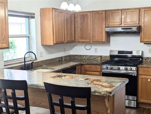 kitchen featuring sink, stone countertops, a kitchen breakfast bar, stainless steel appliances, and ventilation hood