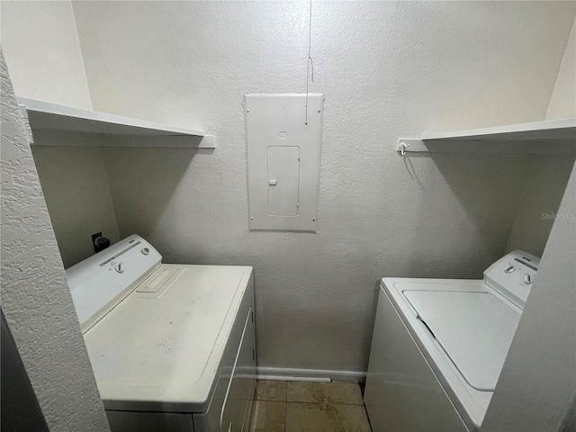 clothes washing area featuring electric panel and washer and clothes dryer