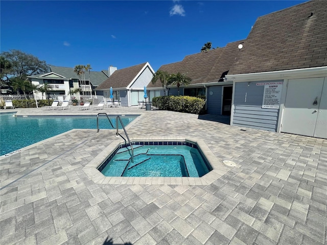 view of swimming pool with a community hot tub and a patio