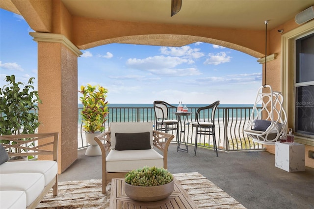 balcony with a beach view and a water view