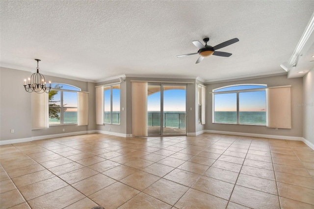 empty room featuring ornamental molding, plenty of natural light, and light tile patterned flooring