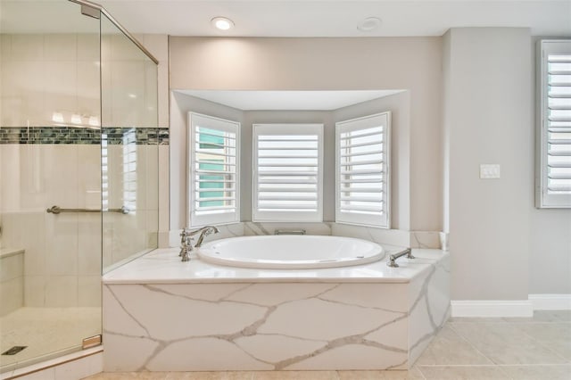 bathroom with independent shower and bath and tile patterned flooring