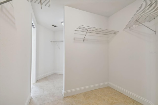 spacious closet featuring light tile patterned flooring