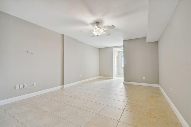 spare room featuring ceiling fan and light tile patterned floors