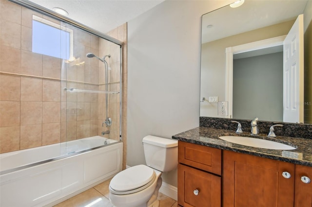 full bathroom with tile patterned flooring, vanity, combined bath / shower with glass door, and toilet