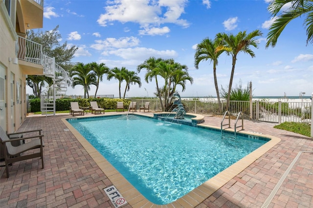 view of swimming pool featuring a hot tub, a patio, and pool water feature