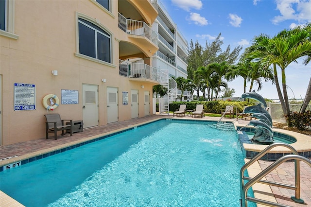 view of pool with pool water feature