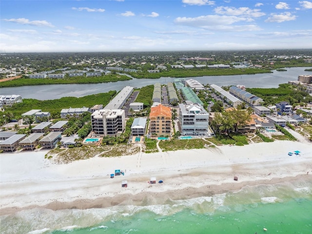 birds eye view of property featuring a beach view and a water view