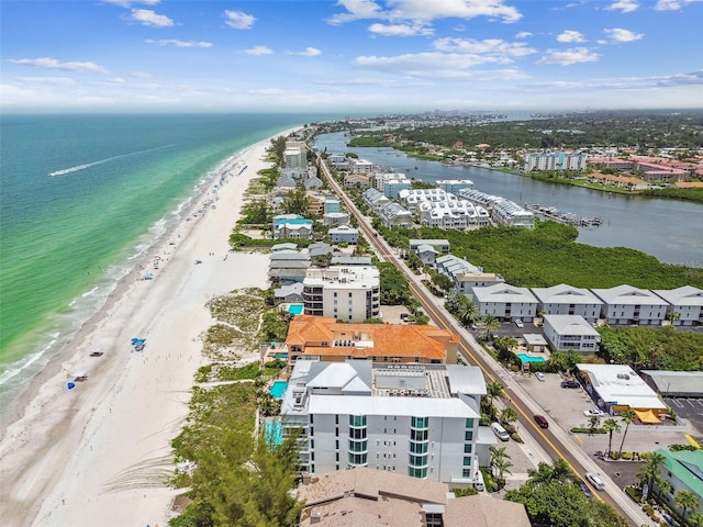 bird's eye view featuring a water view and a beach view