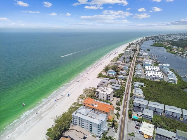 birds eye view of property with a water view and a beach view