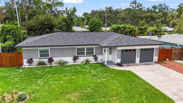 single story home featuring a garage and a front yard