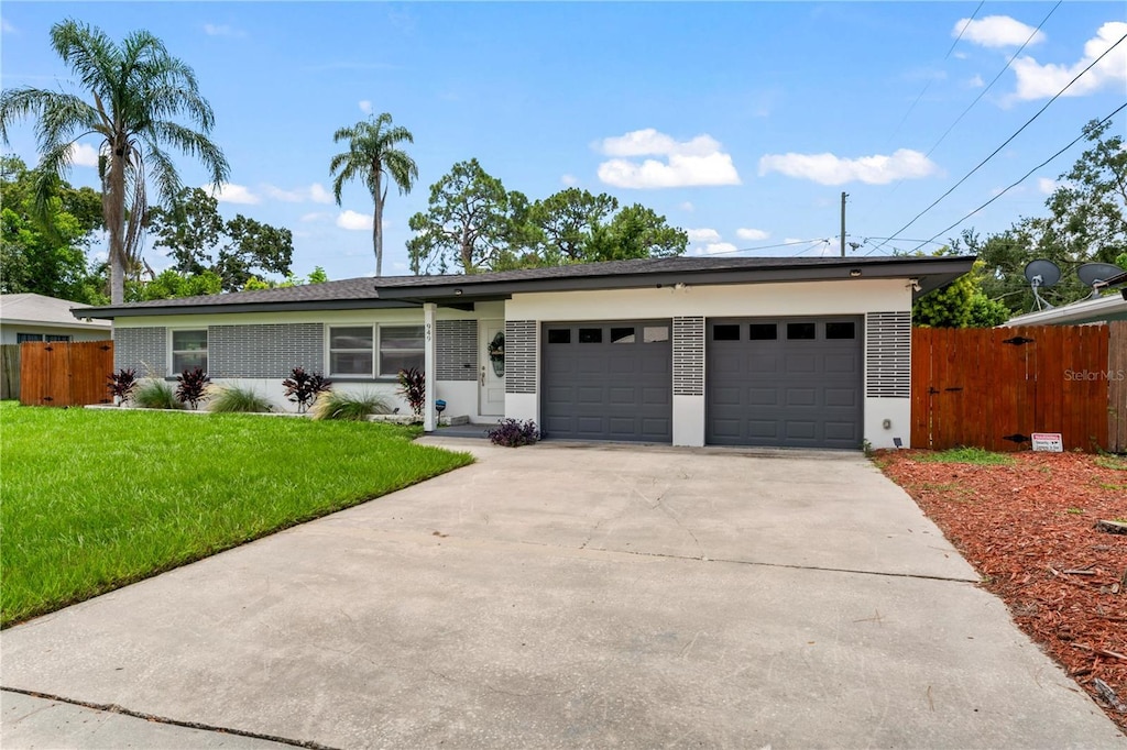 single story home with a garage and a front yard