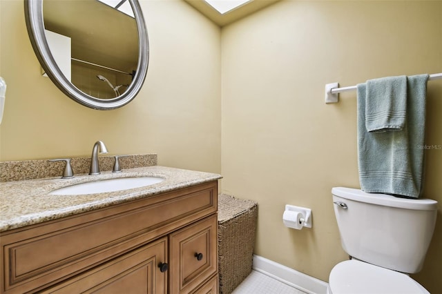 bathroom featuring vanity, tile patterned flooring, and toilet