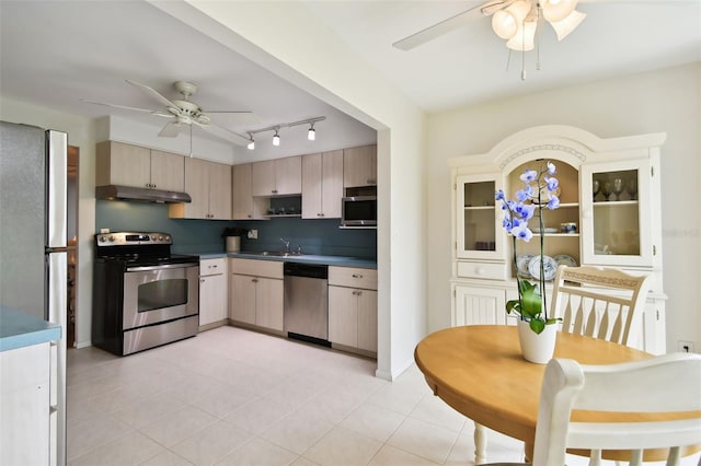 kitchen featuring light tile patterned floors, ceiling fan, stainless steel appliances, track lighting, and light brown cabinetry