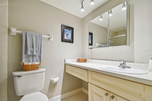 bathroom featuring vanity, toilet, and tile patterned floors