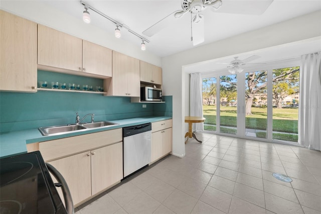 kitchen with light countertops, appliances with stainless steel finishes, light brown cabinets, a sink, and ceiling fan