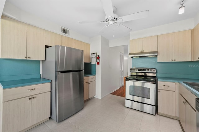 kitchen featuring appliances with stainless steel finishes, visible vents, light brown cabinets, and under cabinet range hood