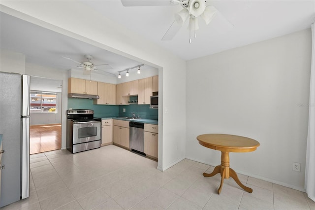 kitchen with stainless steel appliances, light brown cabinets, ceiling fan, a sink, and under cabinet range hood