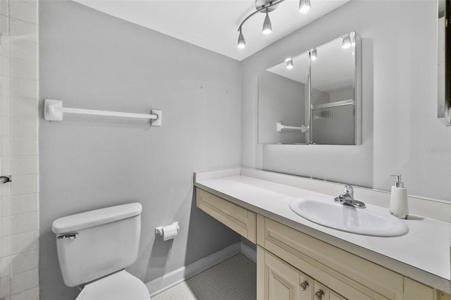 full bathroom with a shower, toilet, vanity, baseboards, and tile patterned floors