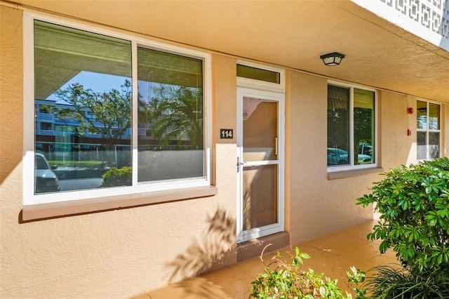 doorway to property with stucco siding