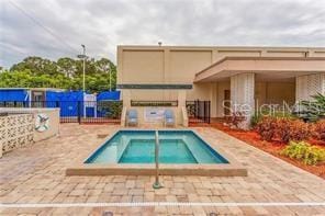 view of swimming pool with a patio area and a hot tub