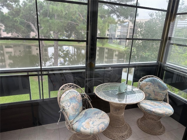 sunroom / solarium with a water view