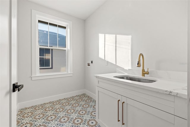 laundry room featuring sink, hookup for a washing machine, and cabinets