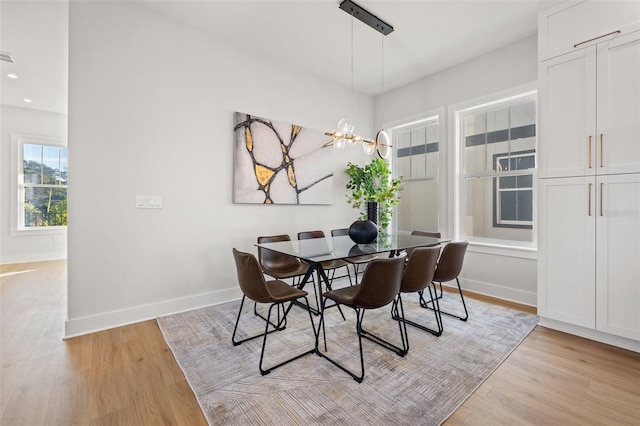 dining room featuring an inviting chandelier and light hardwood / wood-style floors