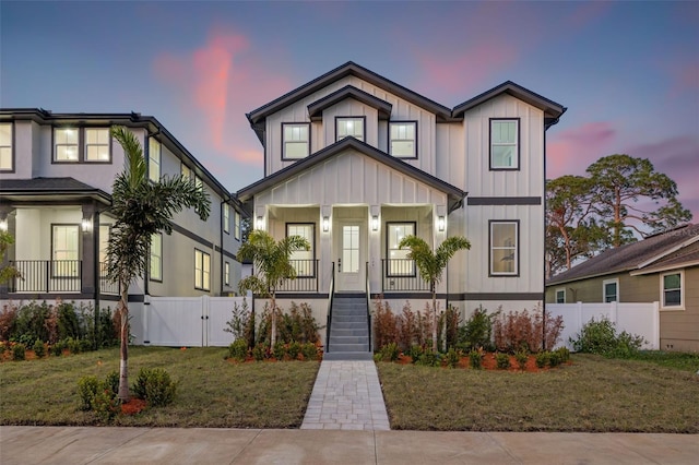 view of front of house featuring a porch and a yard