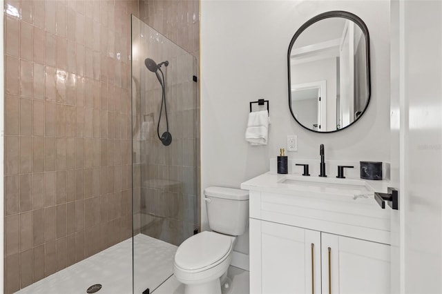 bathroom featuring tiled shower, vanity, and toilet