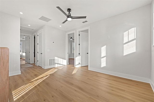 empty room with light wood-type flooring and ceiling fan