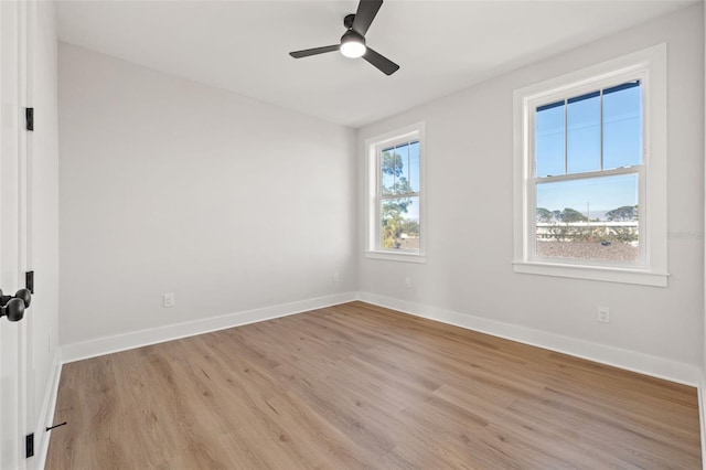 spare room with ceiling fan and light wood-type flooring