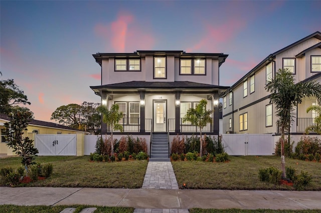 view of front facade featuring a lawn and a porch