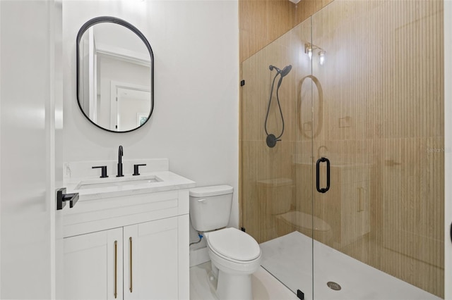 bathroom with vanity, a shower with shower door, and toilet