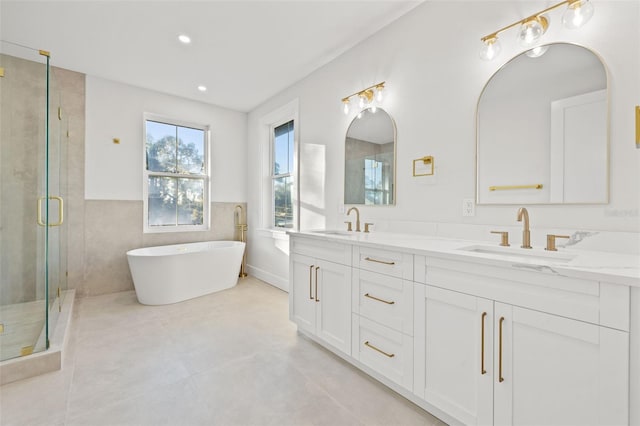 bathroom with shower with separate bathtub and vanity