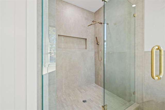 bathroom with a shower with door