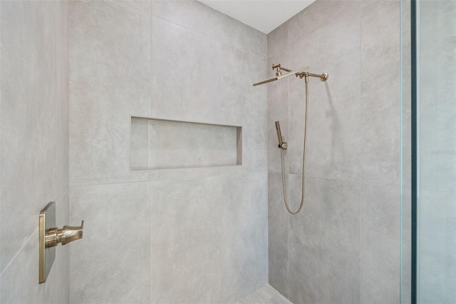 bathroom with tiled shower