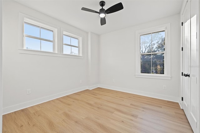 unfurnished room with light hardwood / wood-style floors, a wealth of natural light, and ceiling fan