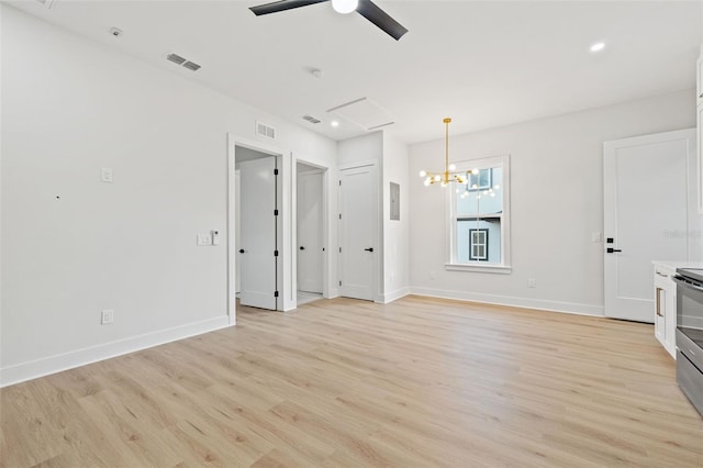 unfurnished living room featuring light hardwood / wood-style flooring and ceiling fan with notable chandelier