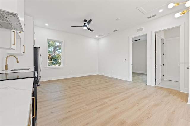 interior space with light hardwood / wood-style flooring, ceiling fan, and sink