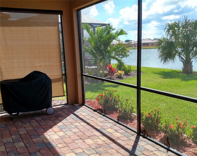 unfurnished sunroom with plenty of natural light and a water view