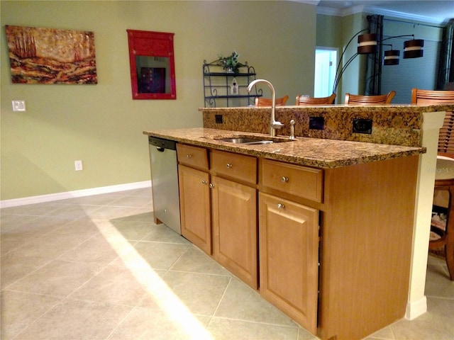 kitchen with sink, stainless steel dishwasher, light tile patterned floors, and a kitchen island with sink