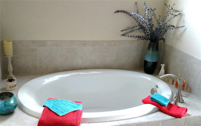 bathroom featuring a relaxing tiled tub