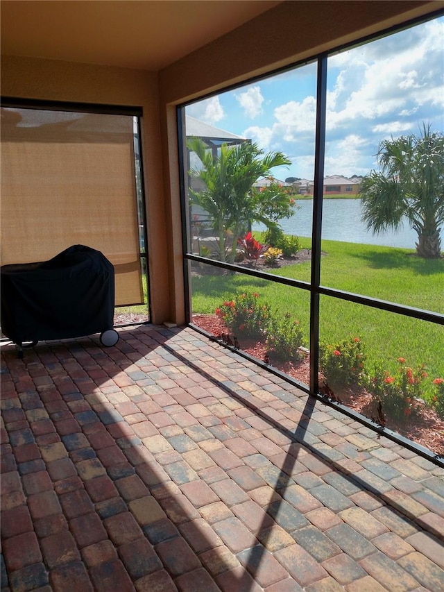 unfurnished sunroom with a water view