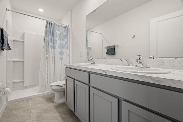 bathroom with toilet, vanity, and a shower with curtain