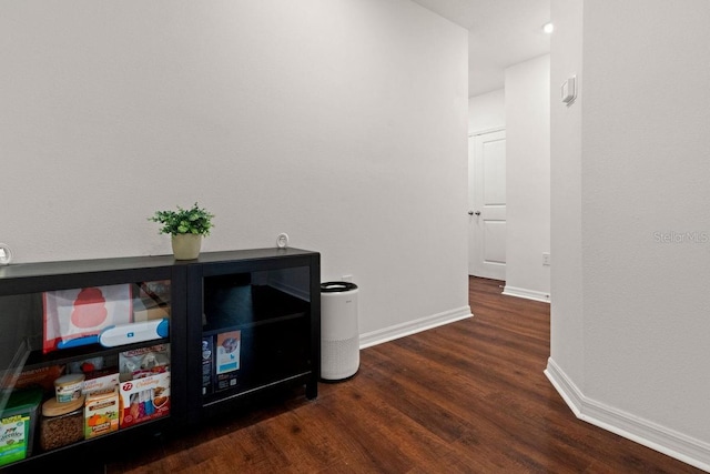 corridor with dark hardwood / wood-style flooring